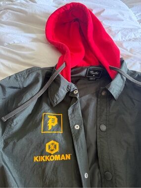 Primitive x Kikkoman Windbreaker Jacket with Red Hood and Yellow Logos